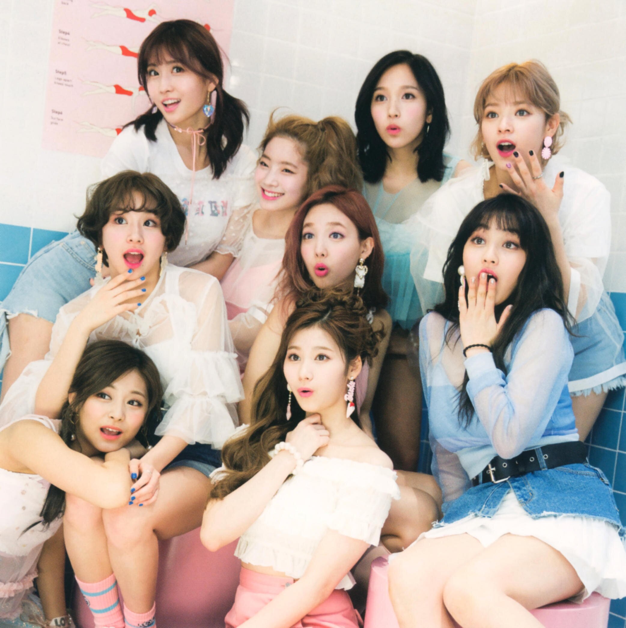 Pink, white, and blue group photo of TWICE during Signal era